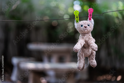 The cat doll was hung on the clothes line