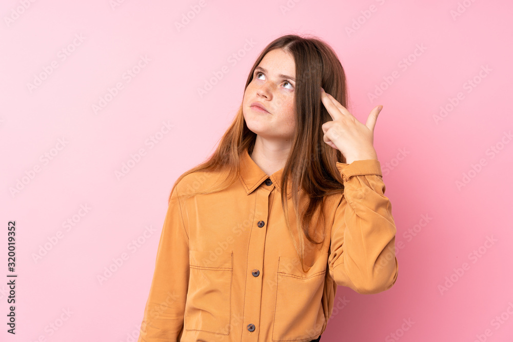 Ukrainian teenager girl over isolated pink background with problems making suicide gesture Ukrainian teenager girl over isolated pink background with problems making suicide gesture