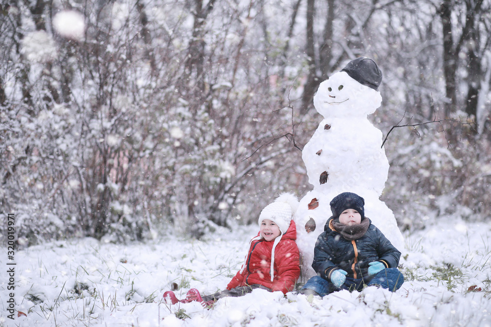 Kids walk in the park first snow Kids walk in the park first snow