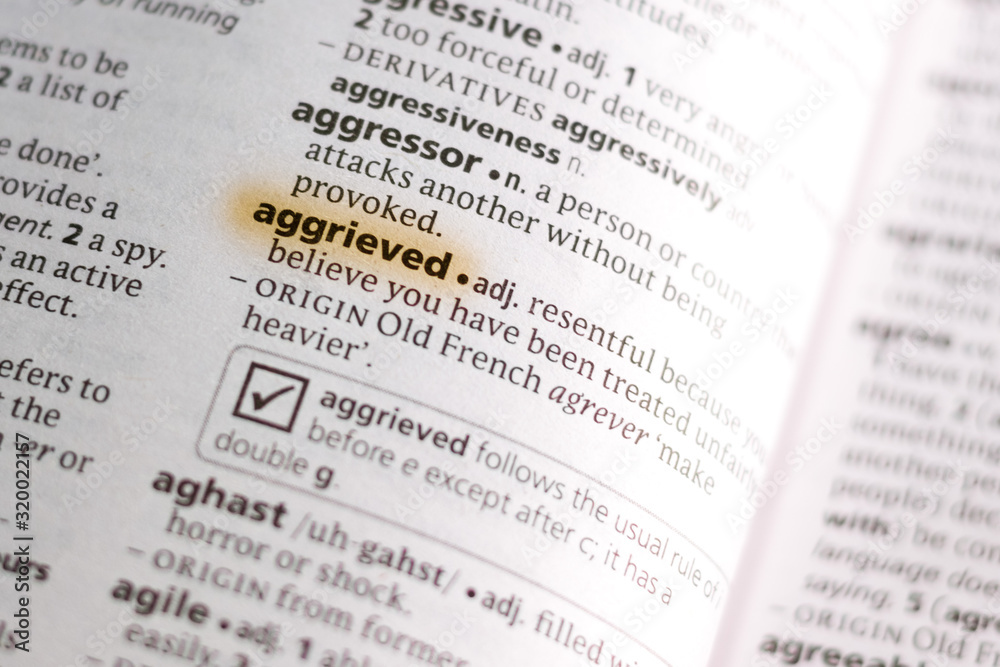 Ivanovsk, Russia - November 19, 2018: The word or phrase Aggrieved in a dictionary. Ivanovsk, Russia - November 19, 2018: The word or phrase Aggrieved in a dictionary.