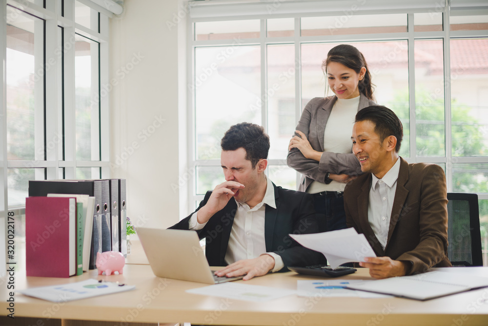 Businessmen are looking at the business plan and business results from the notebook in the office. Businessmen are looking at the business plan and business results from the notebook in the office.
