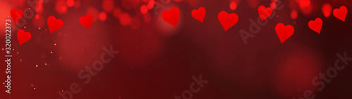 valentine's day background banner panorama - Red hearts and bokeh lights on red festive texture