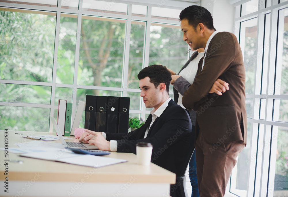 Businessmen are looking at the business plan and business results from the notebook in the office. Businessmen are looking at the business plan and business results from the notebook in the office.