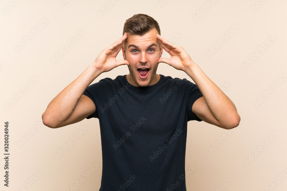 Young handsome blonde man over isolated background with surprise expression Young handsome blonde man over isolated background with surprise expression