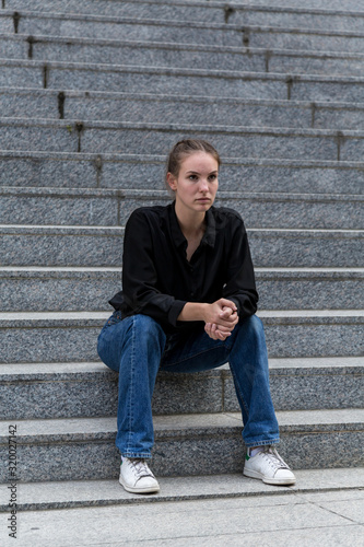 Young Woman Sitting on Outdoor Marble Steps