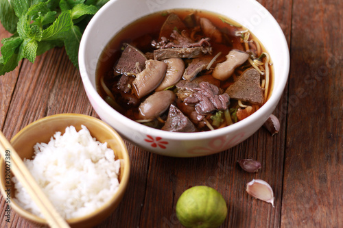 Close up shot of Thailand traditional ekaehla beef soup.( KaoLau) with Rice, food thai style. photo