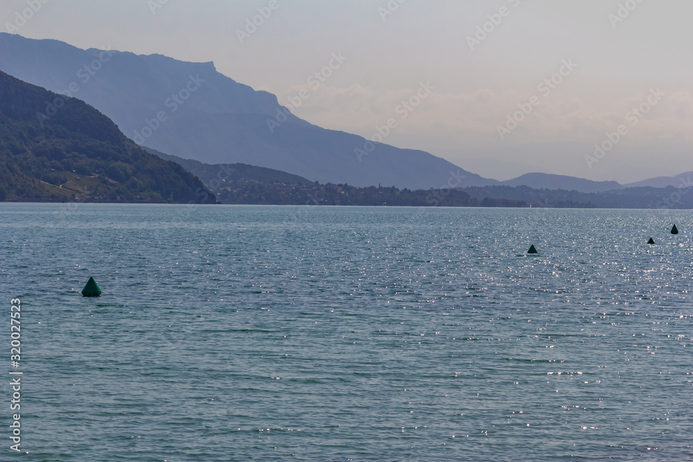 Beautiful summer landscape: blue lake surrounded by mountains, sunny day, France, Lac du Bourget