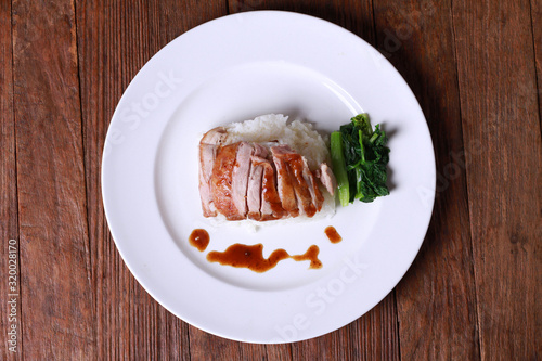 Rice with roast duck on wood table. photo