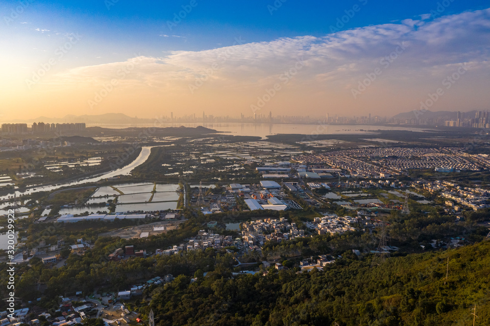 Aerial View of rural green fields in Hong Kong border and skylines in Shenzhen,China