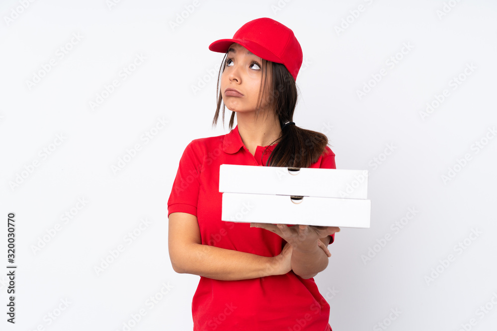 Young Pizza delivery girl over isolated white background making doubts gesture while lifting the shoulders