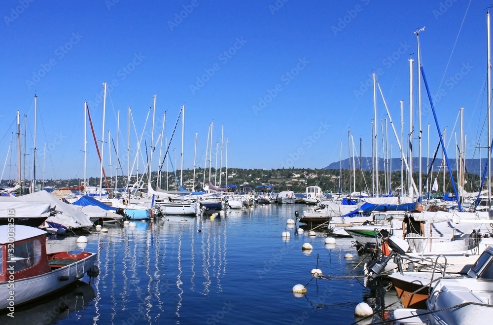 White yachts near the pier on Lake Geneva, Switzerland. Vacation and active pastime theme