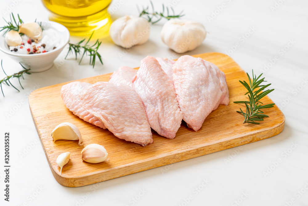 fresh raw middle chicken wings on wooden board fresh raw middle chicken wings on wooden board