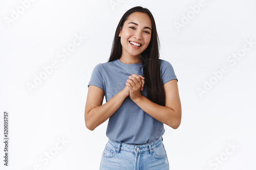 Fotografie Happy, pleased charming asian woman clasp hands touched, receive help and thanki