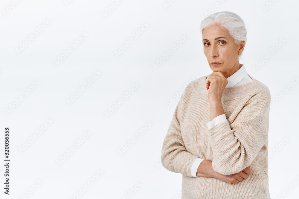 Lady Considering Serious-looking thoughtful smart and elegant, neat senior lady with ...