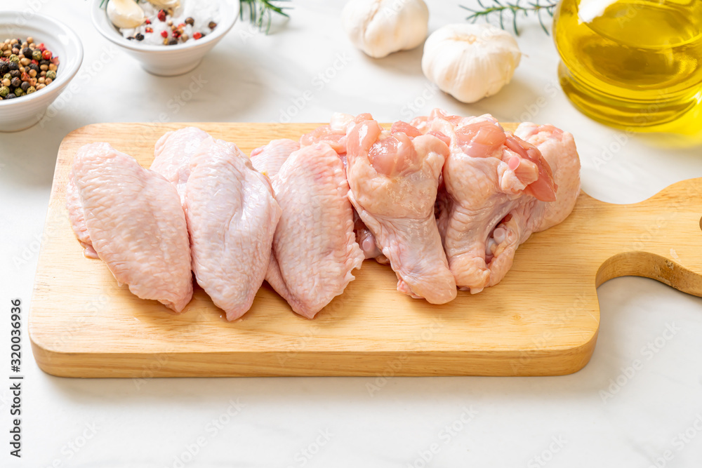 fresh raw chicken wings on wooden board fresh raw chicken wings on wooden board