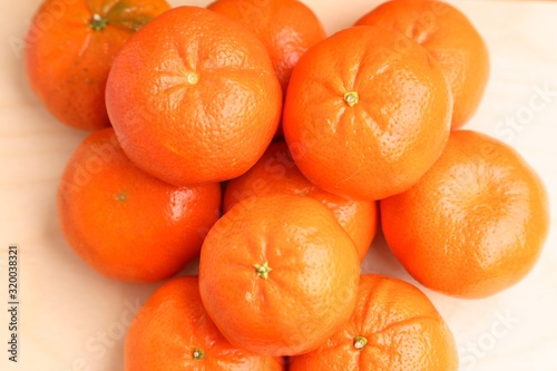 Orange mandarins lie on top of each other bright