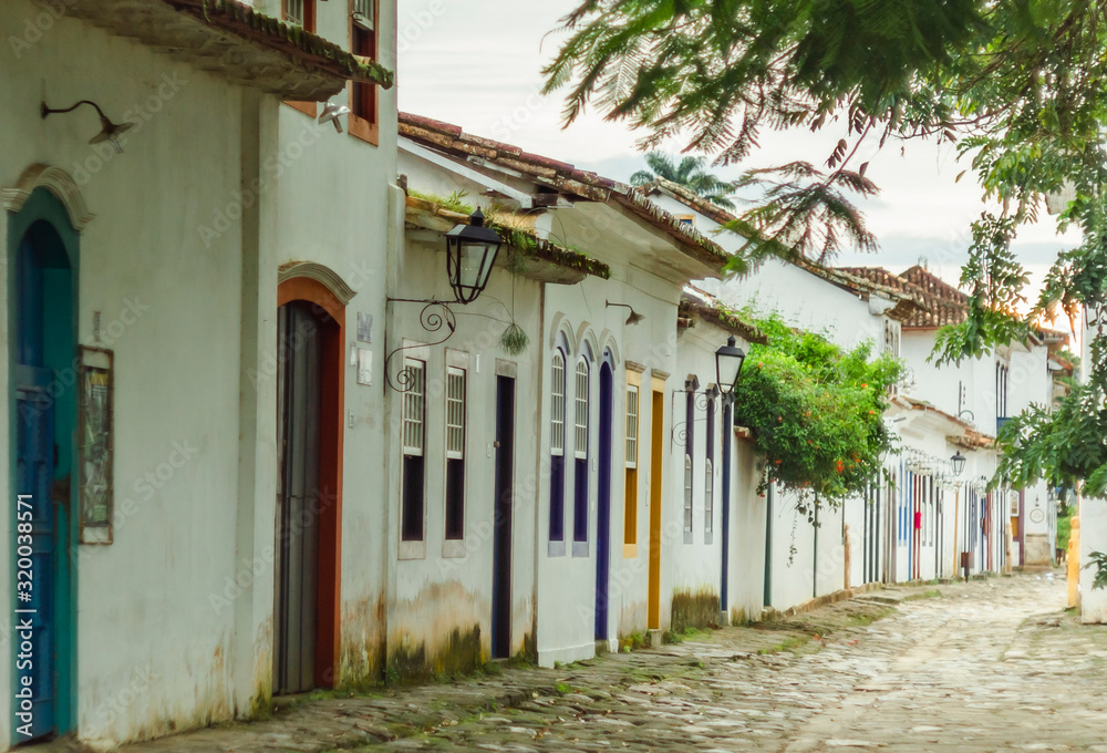 Beautiful green street with colorful doors in the historical center of Paraty, Brazil. Popular tourist destination, travel theme