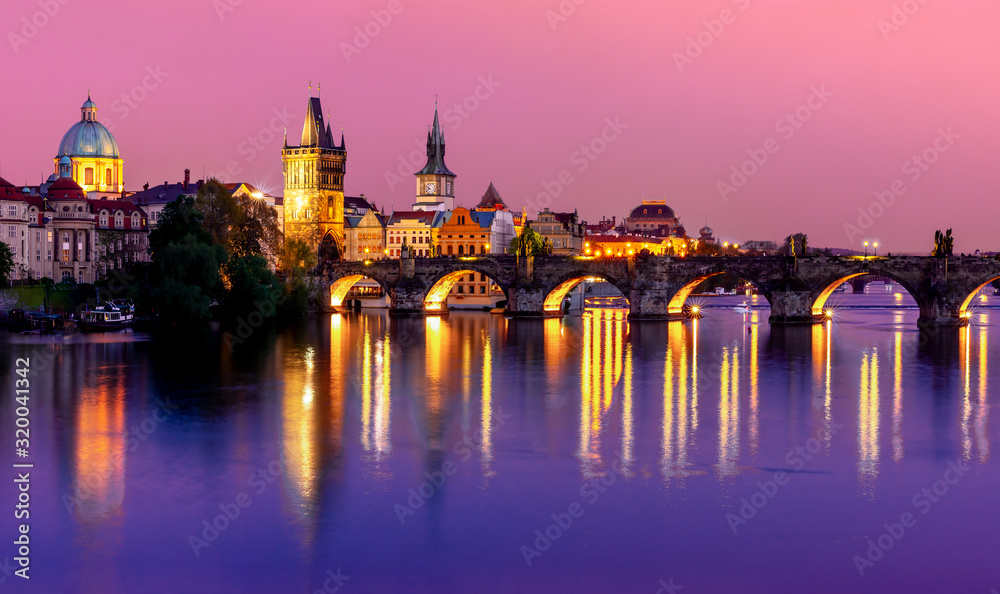 Prague cityscape with Charles bridge over Vltava river at sunset, Czech Republic