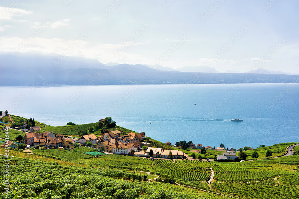 Swiss Houses at Lavaux Vineyard Terraces hiking trail and ship on Lake Geneva and Swiss mountains, Lavaux-Oron district in Switzerland