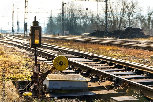 Old railway turnout and rail crossing. Sunlit railroad tracks and tracks running into the distance. Technical background of the sorting station. Czech Republic.