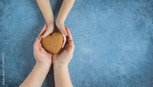 Happy mother's day.Heart in the hands of daughter and mother on a blue background.I love you.Love and health in the family.Banner for the store.Greeting card.Stock.Sale.copy space.mock up.frame