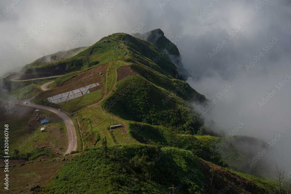 Fototapeta premium Misty clouds cover mountains in Thailand.