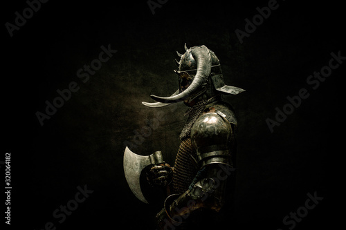 Portrait of a Viking Berserker warrior, holding an ax in his hands