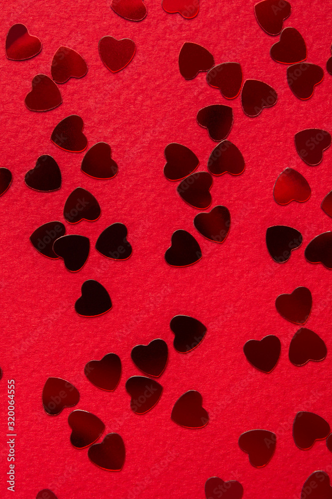 Red heart shape confetti over red background. Top view Red heart shape confetti over red background. Top view