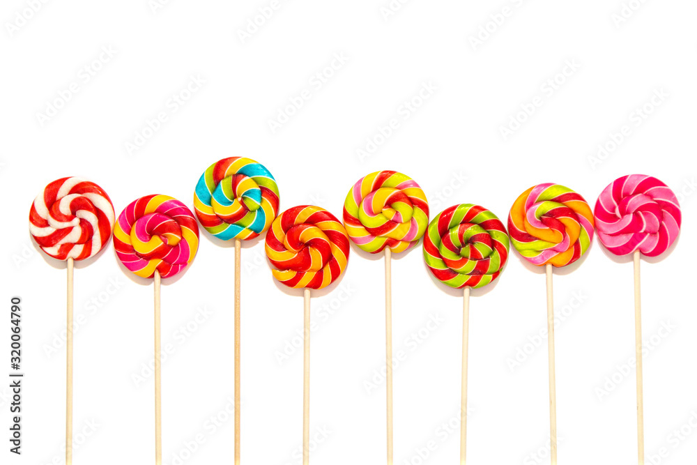 Round multi-colored lollipops on a wooden stick