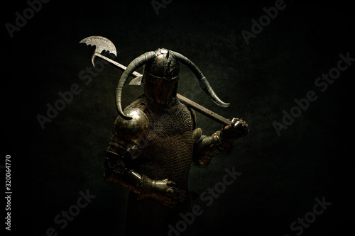 Portrait of a Viking Berserker warrior, holding a halberd on his shoulder