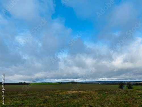 green field and big clouds sky background
