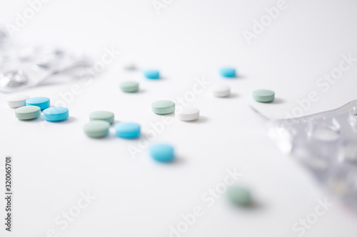 colourful medicine pills with hand. Coronavirus treatment concept