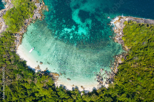 Aerial view drone shot ocean waves, Beautiful tropical beach and rocky coastline and beautiful forest. Nga Khin Nyo Gyee Island Myanmar. Tropical seas and islands in southern Myanmar