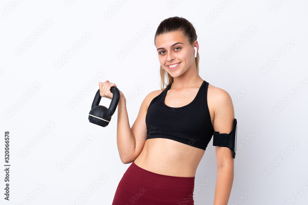 Teenager sport girl over isolated white background making weightlifting with kettlebell Teenager sport girl over isolated white background making weightlifting with kettlebell