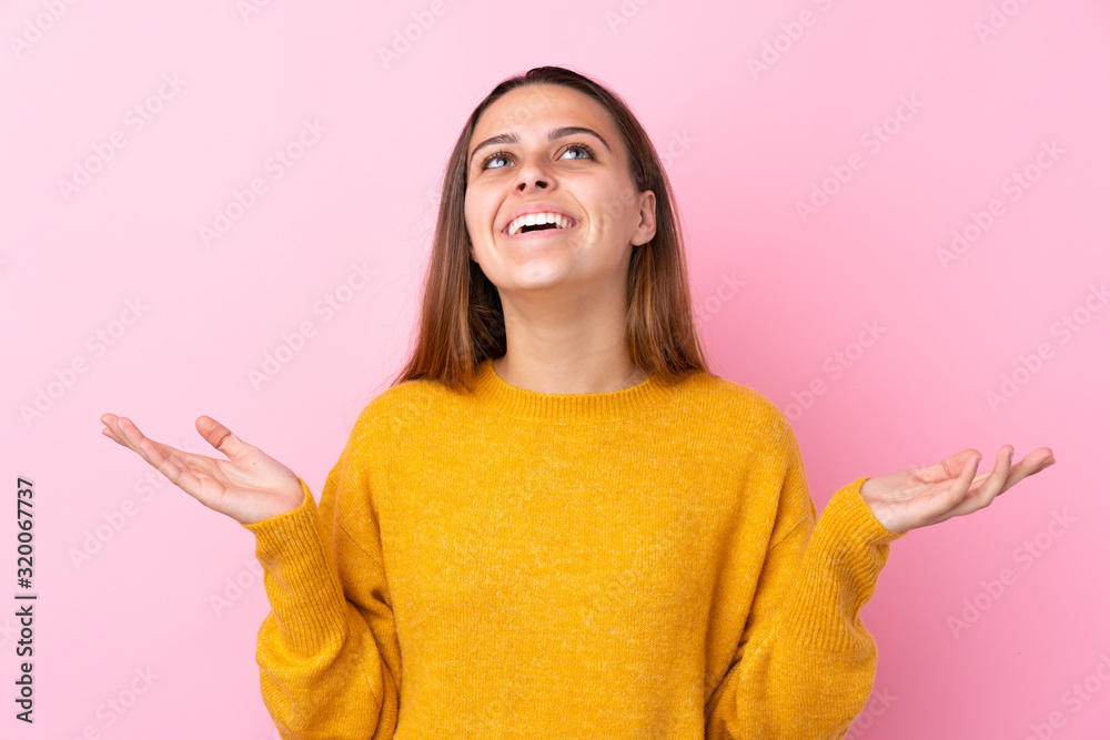 Teenager girl with yellow sweater over isolated pink background smiling a lot Teenager girl with yellow sweater over isolated pink background smiling a lot