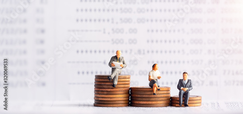 Miniature people: Elderly people sitting on coins stack. Retirement planning. money saving and Investment. Time counting down for retirement and pension.