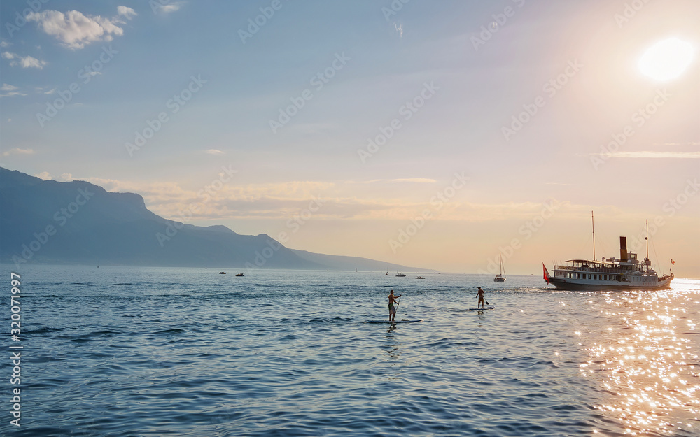 Vevey, Switzerland - August 28, 2016: Excursion ferry and peope at Geneva Lake in Vevey, Vaud canton of Switzerland. Alps mountains on the background