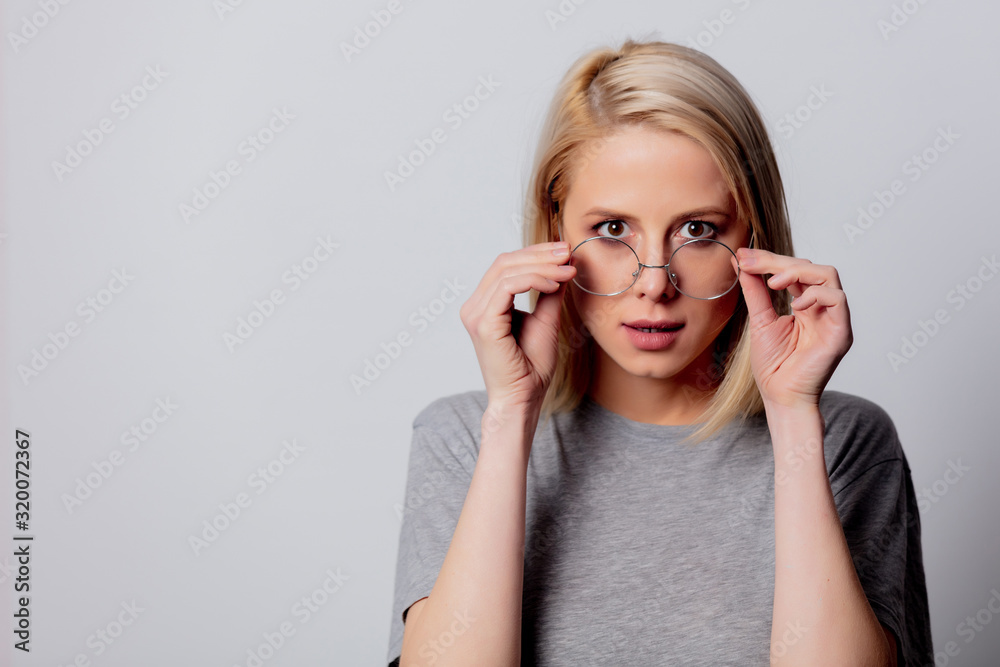 serious blonde woman in glasses on white background serious blonde woman in glasses on white background