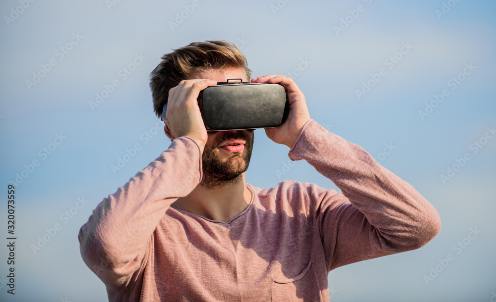 Man wear wireless VR glasses headset. Use modern technology. Virtual reality goggles. Digital future and innovation. Engineering project. Augmented reality. Virtual reality. Cyber space. Game online Man wear wireless VR glasses headset. Use modern technology. Virtual reality goggles. Digital future and innovation. Engineering project. Augmented reality. Virtual reality. Cyber space. Game online
