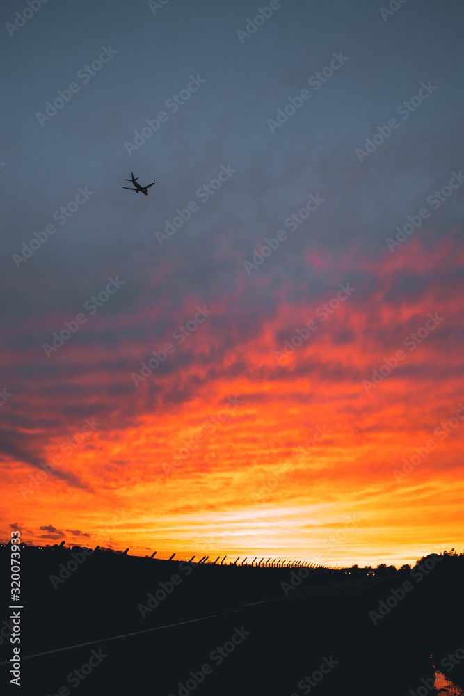 A Plane Flying Into The Sunset