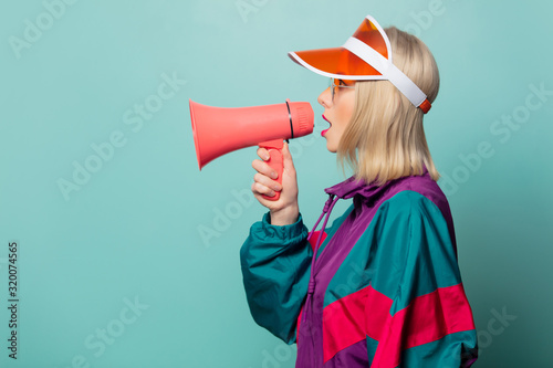 Style blonde woman in glasses with loudspeaker photo