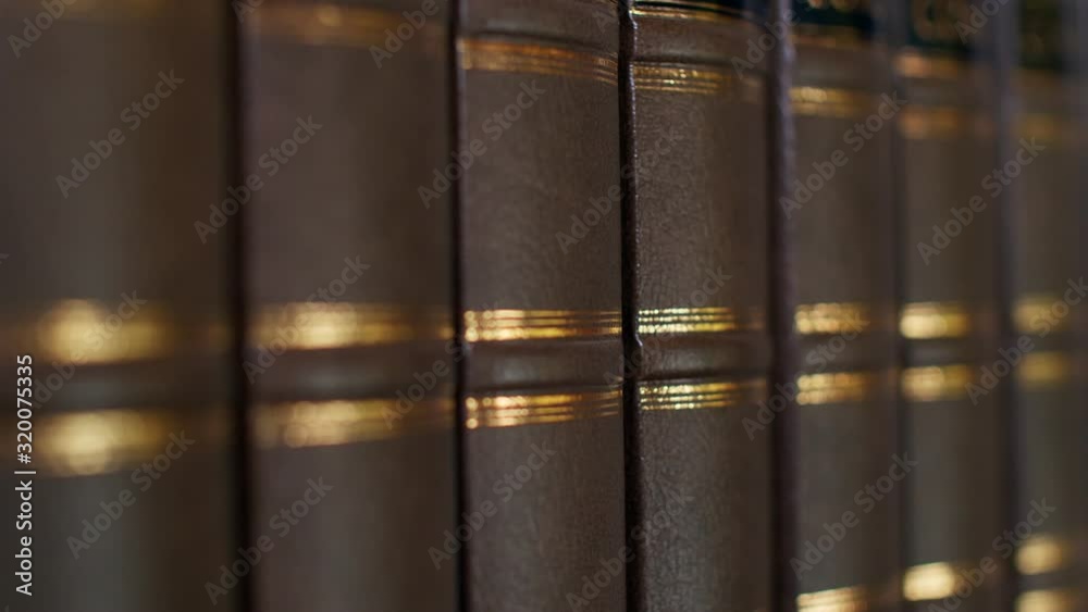 Books on the table in library, shallow depth of field. Books with a luxurious leather binding. 4k Books on the table in library, shallow depth of field. Books with a luxurious leather binding. 4k
