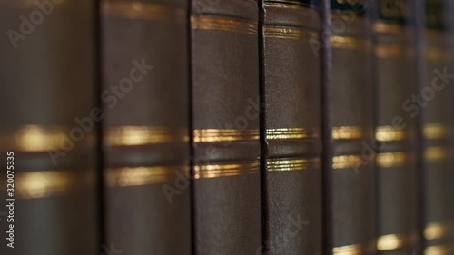 Books on the table in library, shallow depth of field. Books with a luxurious leather binding. 4k