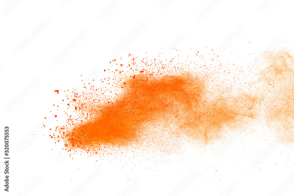 Abstract orange powder explosion. Closeup of orange dust particle splash isolated on white background.