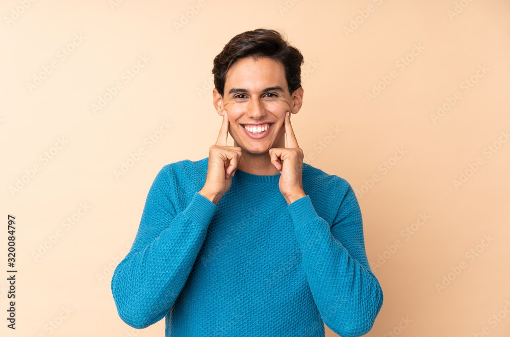 Man over isolated background smiling with a happy and pleasant expression