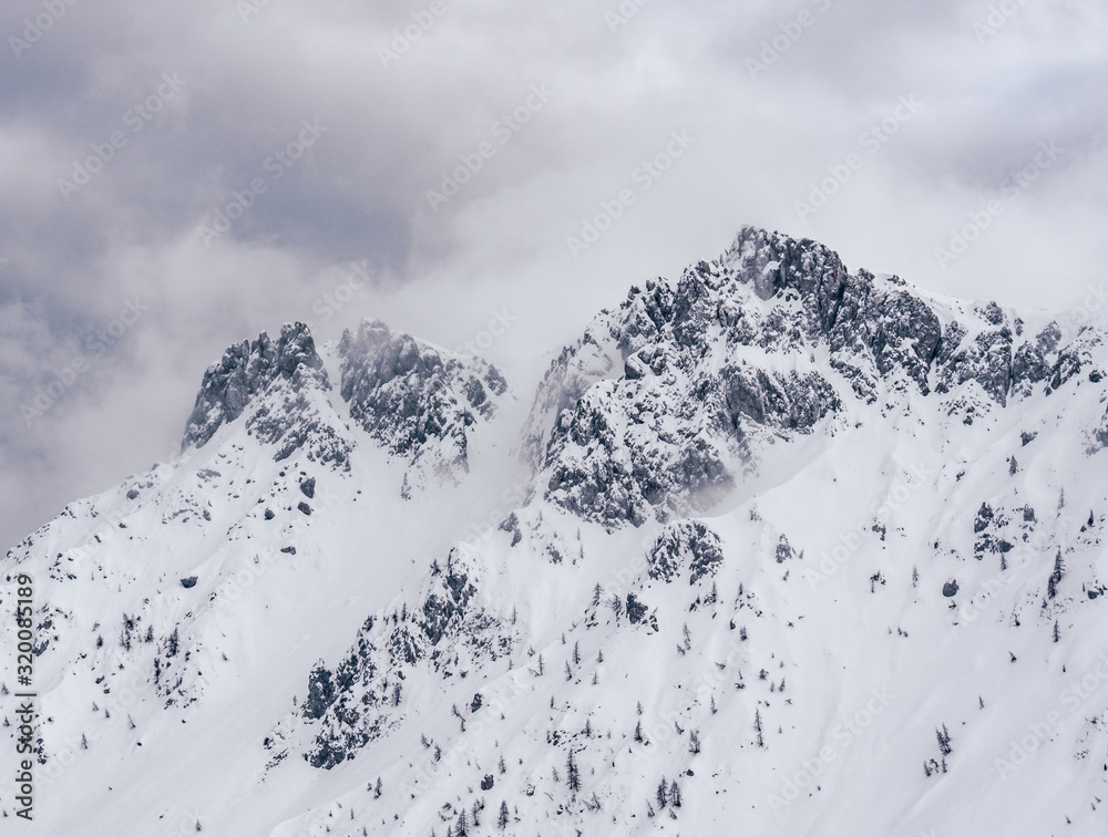 Obraz premium Winter in the mountains and the snowy valleys of the Alps during a fantastic winter day, near the town of Schilpario, Italy - January 2020.