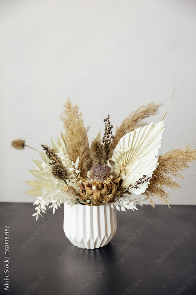 Composition dried colored flowers on a white background. Romantic flowers. Place for text and design. Greeting card. Flat lay, top view. Bouquet of dried wild flowers 