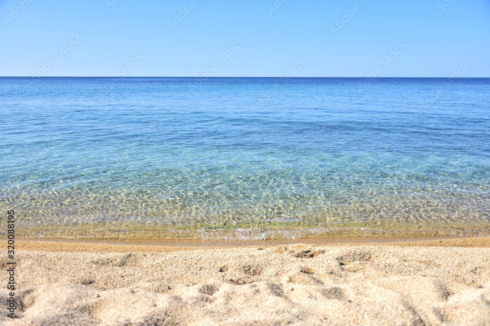 Seascape of amazing beach with blurred azure sea water in sunny day. Amazing natural beach with white stones and turquoise water. crystal clear sea. Halkidiki Greece Blue Flag Beach
