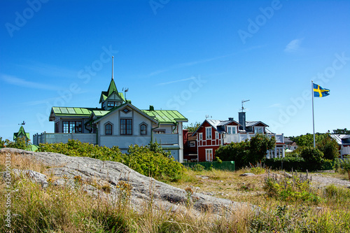 Typical swedish wooden houses on a hill in Sandhamn, Sweden photo
