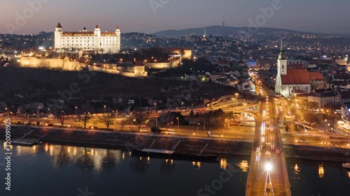 Day to night aerial hyper lapse of Bratislava old town and castle, view from SNP bridge. Slovakia. photo
